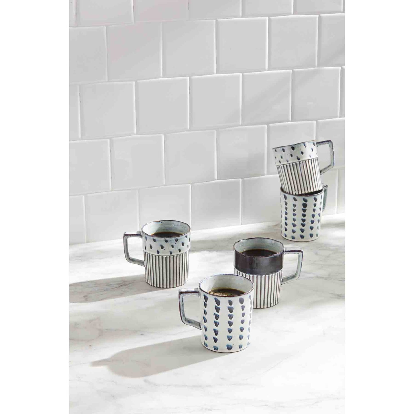 Display of blue dot and ribbed coffee mugs