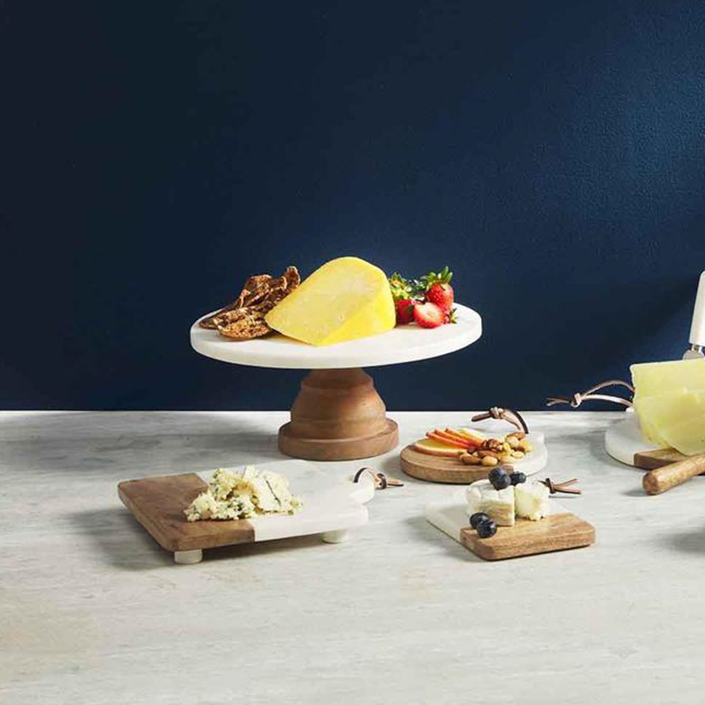 cake stand with a wooden carved base and white marble top