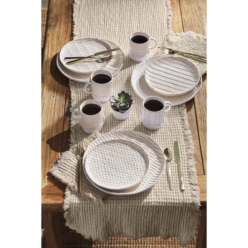 Tablescape with white stoneware cups and plates. 